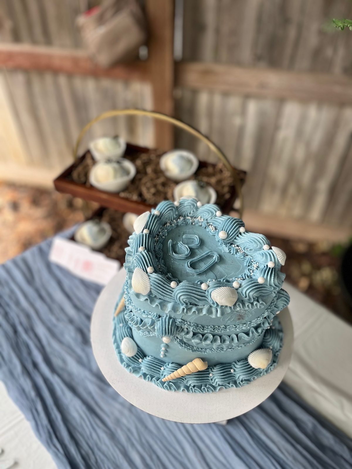 Blue and white beach and shell-themed tiered cake made by Bipity Bopity Cakes, Lodi CA bakery