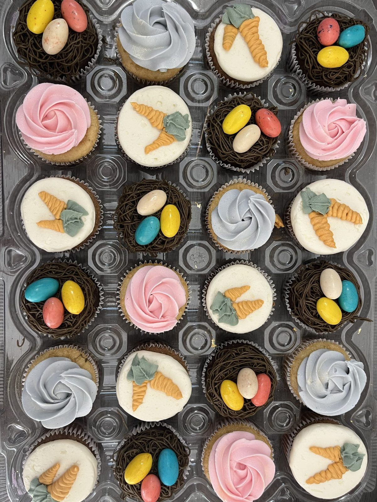 Easter-themed cupcakes with carrot and pastel egg decorations made by Bipity Bopity Cakes, Lodi CA bakery