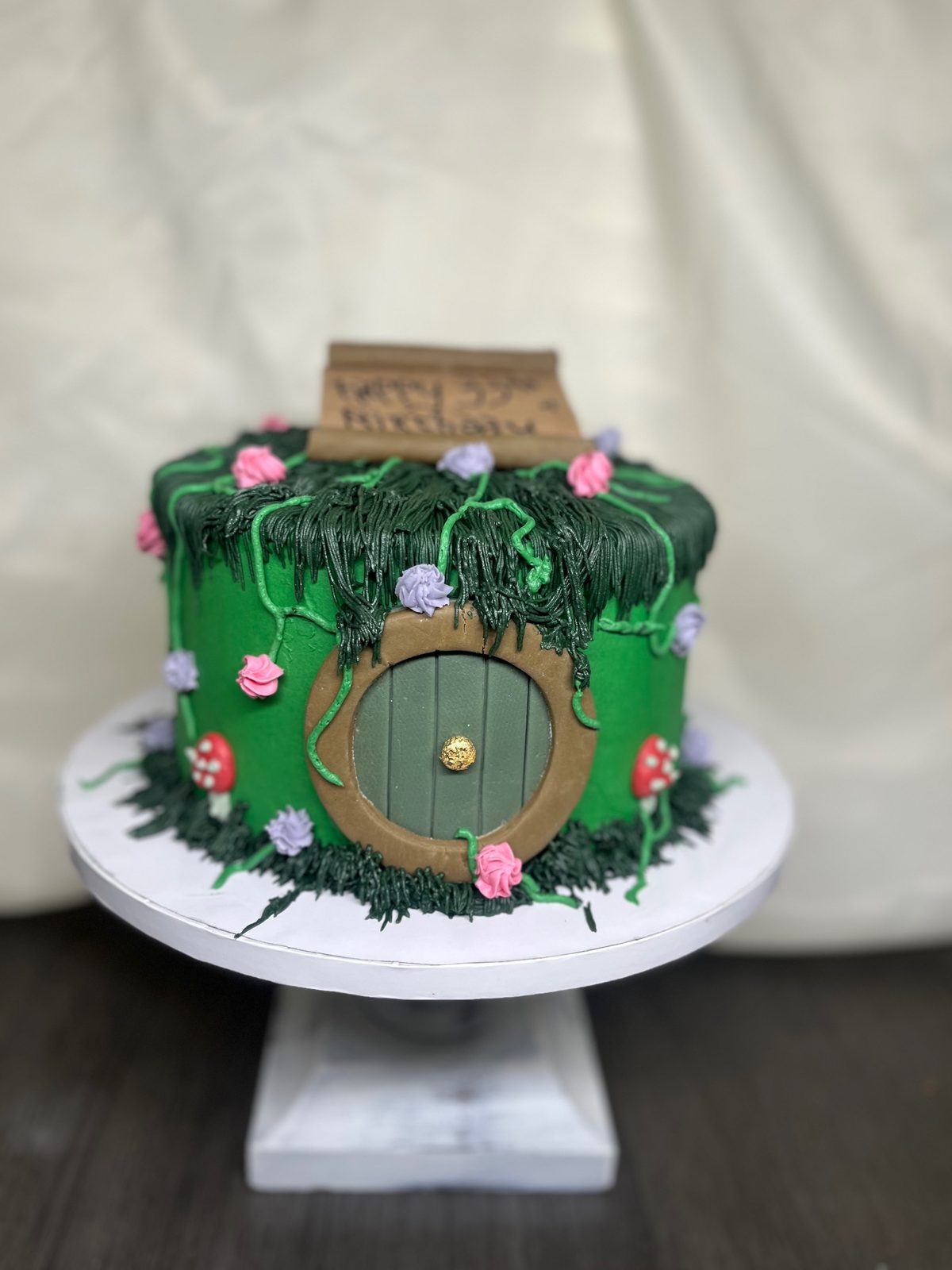 Whimsical green fantasy hobbit-house themed cake made by Bipity Bopity Cakes, Lodi CA bakery